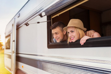 Young couple sitting in a camper van