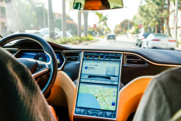 Los Angeles, United States - May 17, 2013: A cockpit with LCD digital speedometer and steering wheel of electric car Tesla Model S during drive. Tesla electric cars are produced by Tesla Motors, Inc. in California, USA.