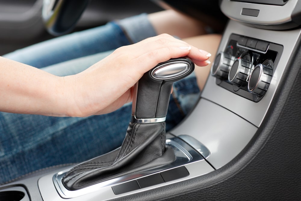 hand changing gears on an automatic car transmission