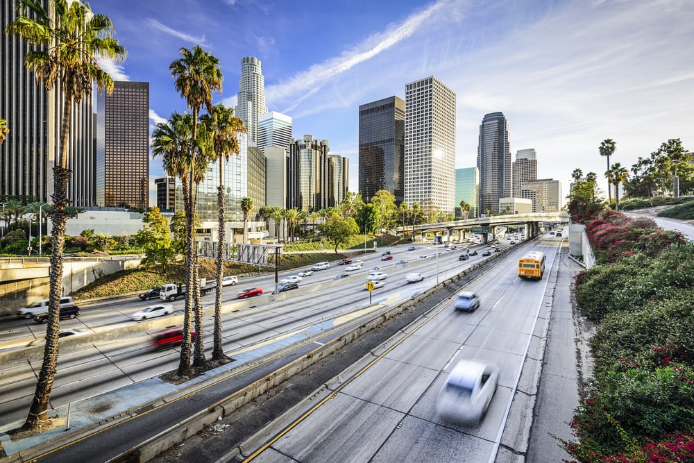 panoramic view of california highway with skyline and insured cars