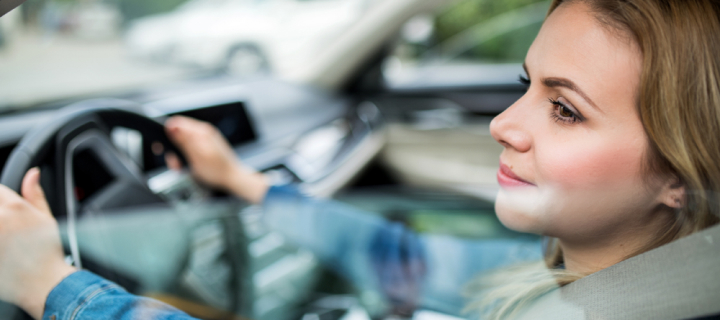 Woman driver sitting in car.